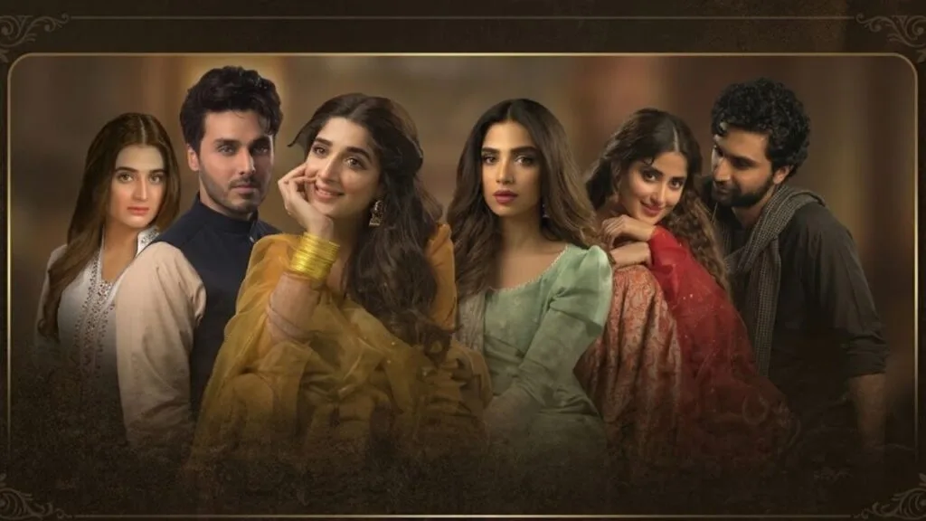 This image is an official promotional ensemble poster for the critically acclaimed 2018 Pakistani period drama serial Aangan, which was broadcast globally on HUM TV. The visual layout presents six core members of the star-studded cast arranged side-by-side in traditional mid-20th-century attire, capturing the melancholic, pre-partition romantic essence of the narrative. From left to right, the actors featured are Hira Mani, Ahsan Khan, Mawra Hocane, Sonya Hussyn, Sajal Aly, and Ahad Raza Mir, each portraying characters whose complicated personal relationships interweave against the backdrop of shifting political ideologies and family feuds in British India. Framed by a subtle, vintage gold-bordered overlay, the composition showcases Mawra Hocane’s character prominently in a vibrant yellow ensemble with classic traditional jewelry near the center, while Sajal Aly and Ahad Raza Mir flank the right side, highlighting the heavy emotional gravity and dramatic arcs that define this cinematic television adaptation.