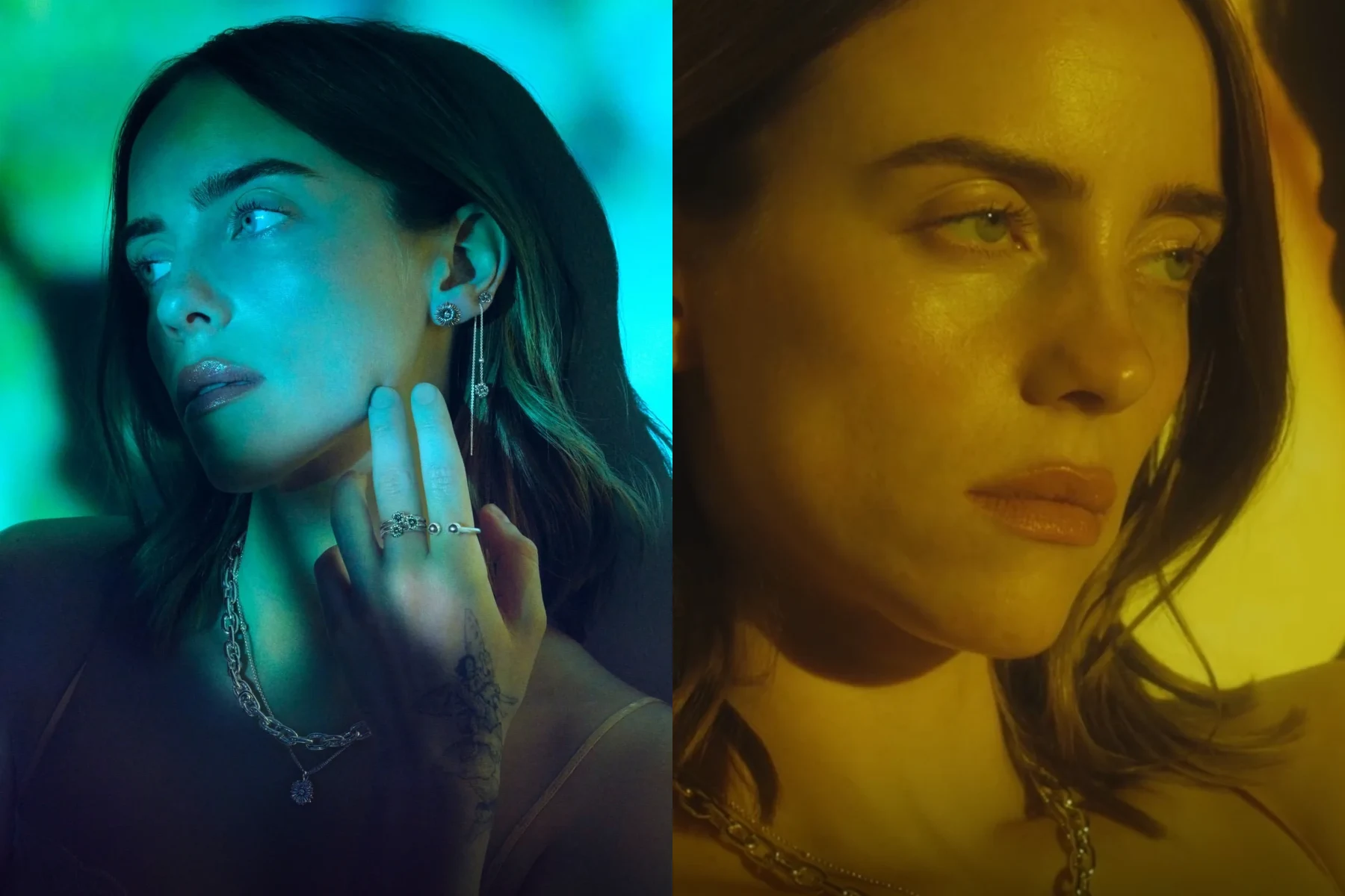 A side-by-side composite photo features two close-up profile and portrait shots of American singer Billie Eilish under moody, atmospheric lighting for a jewelry campaign. On the left, she is bathed in deep blue and green light, her head turned to the left with a reflective expression as her tattooed right hand gently touches her face, showcasing a collection of silver statement rings, a chunky silver link chain necklace with a small pendant, and multiple earrings—including a long, delicate drop chain earring with floral motifs. On the right, a warm, golden-yellow hue illuminates a dramatic, tightly cropped close-up of her face as she looks thoughtfully downward, her dark, prominent eyebrows and subtle lip gloss catching the light while a heavy silver chain necklace frames her collarbone.