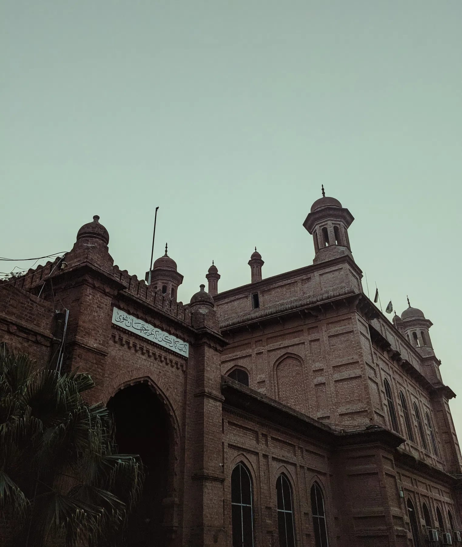 The National College of Arts (NCA) Lahore stands as Pakistan's premier, federally chartered public art university and the second-oldest art institution in South Asia. Founded in 1875 as the Mayo School of Industrial Arts to safeguard and document regional craftsmanship under the British Raj, the institution's pedagogical roots were deeply influenced by the global Arts and Crafts Movement. Its inaugural principal, British artist and curator John Lockwood Kipling, established a curriculum that uniquely fused traditional Punjabi and Mughal craft techniques with European perspective-drawing methods. This design-and-craft ethos crystallized architecturally in the college's historic campus on Mall Road. Designed by the pioneering master builder Bhai Ram Singh and constructed by the legendary engineer Sir Ganga Ram, the iconic campus features red-brick, Indo-Saracenic facades, protective verandas, structural arches, and ornamental chatris. The historic Kipling Block, whose foundation stone was laid in 1880, serves as a physical anchor directly adjacent to the Lahore Museum, which was originally curated alongside the school to provide students with raw reference material.Following Pakistan's independence, the facility underwent a radical modernization in 1958 under the guidance of its first Pakistani principal, Mian Barkat Ali. Restructured into the National College of Arts, the university successfully decolonized its curriculum by importing global design methodologies and integrating experimental, non-conformist practices. Today, the institution organizes its academic scaffolding across the faculties of Art, Design, Architecture, Film & Television, and Performing Arts. It accommodates diverse specializations ranging from traditional Miniature Painting and Ceramic Design to contemporary Musicology and Visual Communication Design. Entrance is exceptionally competitive, drawing talent nationwide via a strict, multi-tiered provincial quota system, written testing, and rigorous live drawing examinations. This immersive, studio-centric cultural melting pot has birthed generations of visionary changemakers. Its alumni include modern art pioneers like Zahoor ul Akhlaq and Salima Hashmi, alongside prominent contemporary cultural icons like Ali Zafar and Ayesha Omar. Expanding its national reach, NCA also hosts specialized satellite campuses—including its Rawalpindi Campus and the newly inaugurated Gilgit-Baltistan Campus—solidifying its role as a monumental pillar of artistic scholarship, creative freedom, and cultural preservation across the region.