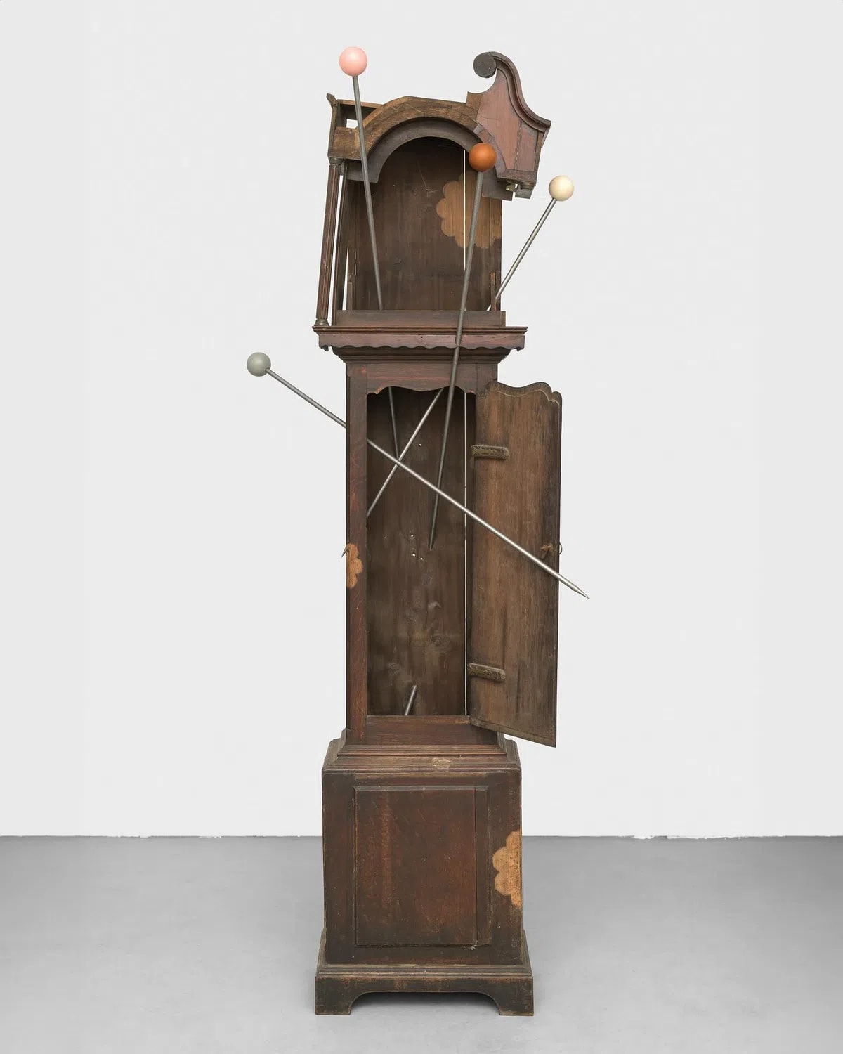 Ginny on Frederick presents Alexandra Metcalf at Art Basel, Statements Booth M8 from June 19—22, 2025.  - Assembly is a series by Alexandra Metcalf that transforms four antique grandfather clocks— longstanding symbols of authority and patriarchal order—into intimate explorations of control, care, and bodily autonomy. Each clock is named after a man, reflecting Metcalf’s own personal relationships marked by both tenderness and control. Opened interiors reveal dioramas, stained glass, surgical tools, and domestic fragments, turning sites of order into spaces of resistance and reassembled memory. These interventions render the clocks vulnerable, exposed, and unsteady, undermining their traditional roles as keepers of order. They gesture toward invasive procedures, institutional oversight, and the blurring of nurture with restraint—haunted by the legacy of decisions made about women, rather than with them.  - JACKSON—ASSEMBLY, 2025,  wooden grandfather clock case, steel pins, silicone 214 cm x 84 cm x 60 cm