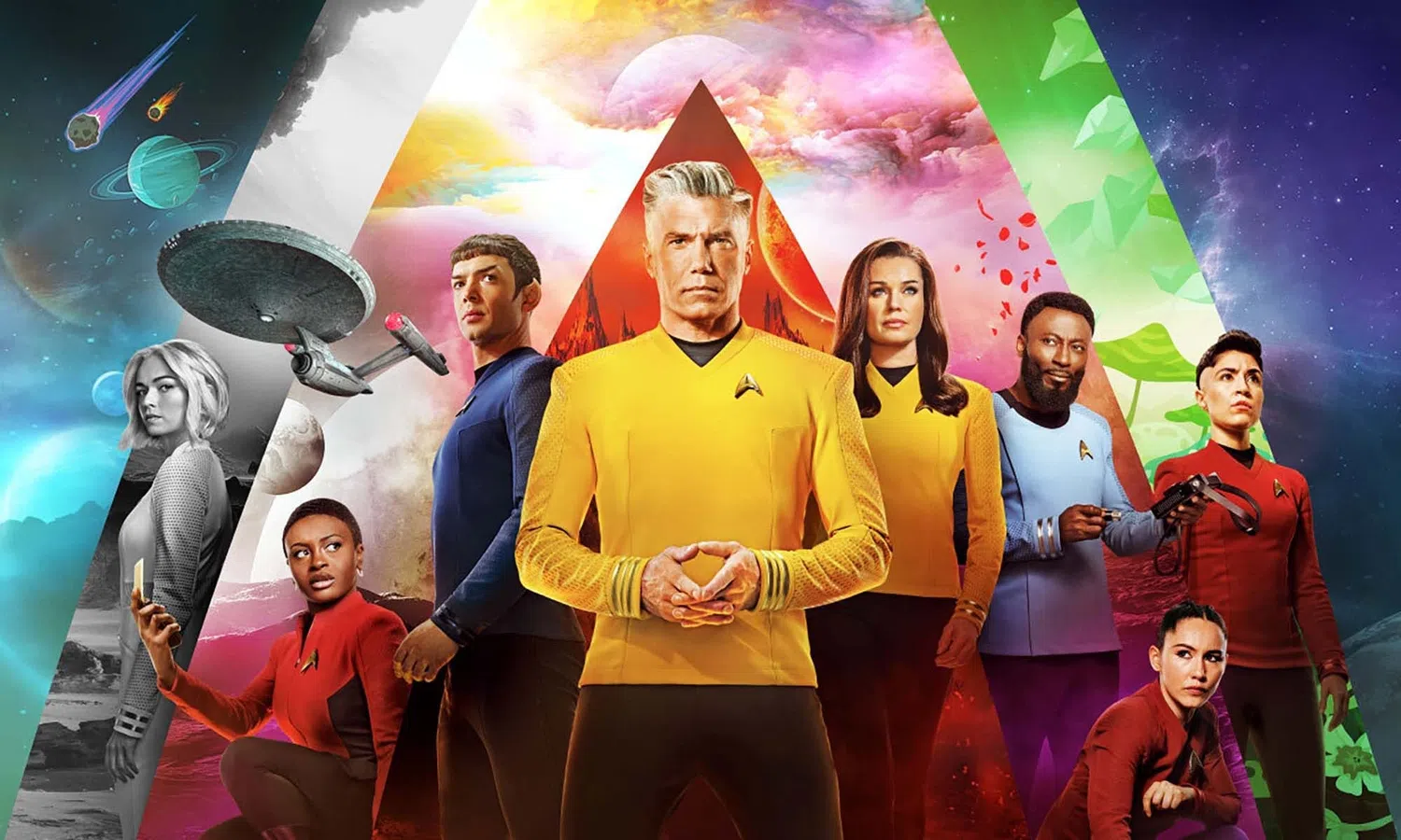 A promotional group poster features nine cast members from the sci-fi series Star Trek: Strange New Worlds arranged against a vibrant backdrop of geometric color segments showcasing different alien planets, space vistas, and nebula skies. In the center stands Captain Christopher Pike, a silver-haired man in a bright yellow Starfleet uniform with his hands clasped together, flanked closely by Spock in a blue uniform on his left and Number One (Una Chin-Riley) in a yellow uniform on his right. Other crew members—including Nyota Uhura, Nurse Christine Chapel, Dr. M'Benga, Erica Ortegas, La'an Noonien-Singh, and another crewmate—are distributed symmetrically around them, wearing their respective red, blue, or yellow uniforms and striking serious, looking-forward poses.
