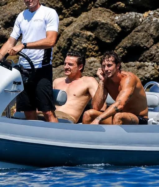 Actor Pedro Pascal was photographed shirtless alongside male model Christian Hogue aboard a luxury tender boat during a high-profile vacation. The relaxed outing took place in late July 2026 off the scenic coast of Mallorca, Spain, where the Hollywood star joined a star-studded group of close celebrity friends, including actor Jason Bateman and director Judd Apatow, to soak up the Mediterranean summer sun. 