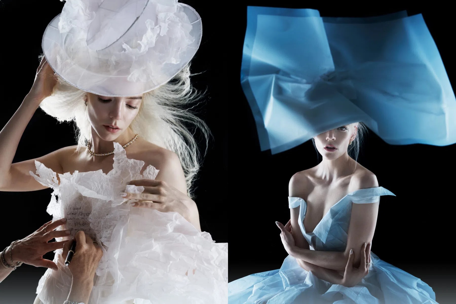 An image collage shows actress Anya Taylor-Joy posing in avant-garde, ethereal garments made from textured paper against a stark black background. On the left, she looks downward while wearing an elaborate, translucent white paper hat and a ruffled white paper gown. Another person's hands are visible in the lower left corner, writing text onto the bodice of her dress with a marker. Her blonde hair is styled in a voluminous, wind-blown fashion, and she wears a delicate gold chain necklace. On the right, she faces forward, wearing an architectural, oversized blue paper headpiece that partially veils her face, paired with an off-the-shoulder light blue paper dress. Her hair is tied back, and the dramatic side-lighting highlights the sculptural qualities and crisp folds of both outfits.