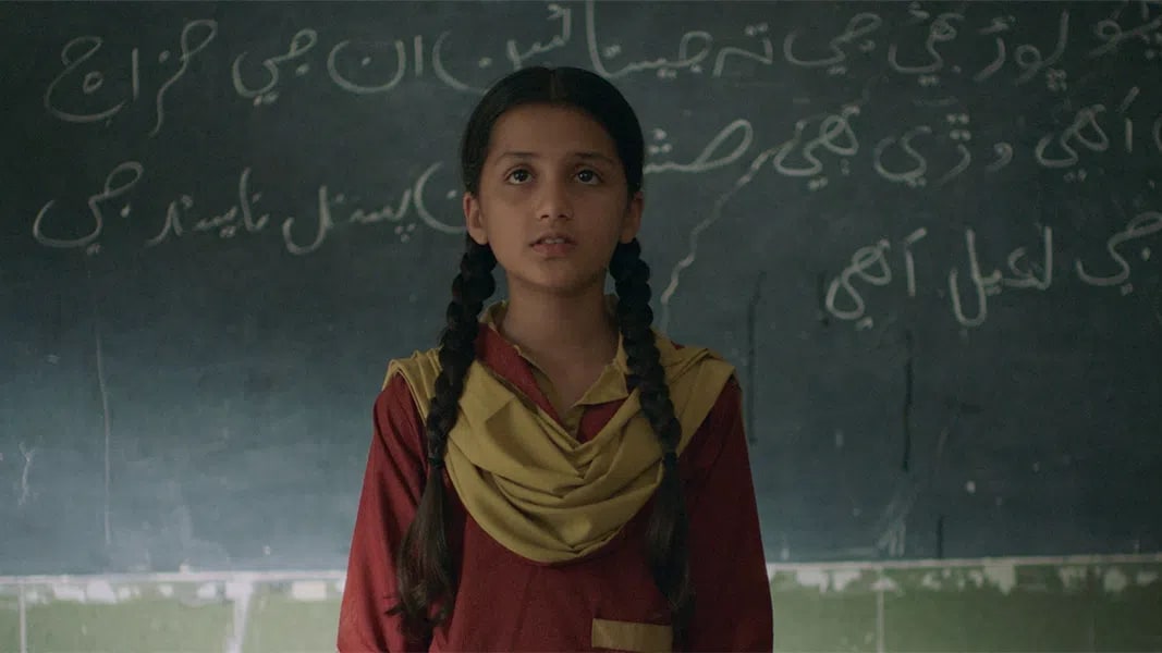 The term "Ghost School" refers to both a critical socio-political issue in Pakistan and an internationally acclaimed 2025 feature drama film directed by Seemab Gul that highlights this crisis. In reality, a "ghost school" is an official term for an educational institution that exists only on paper or has been completely abandoned; while the government continues to allocate monthly budgets for maintenance and teacher salaries, the funds are routinely siphoned off by corrupt local politicians or "ghost teachers" who get paid but never show up, leaving thousands of rural school buildings to fall into ruin or be repurposed as private cattle sheds. Gul’s film uses a blend of social and magical realism to explore this structural corruption through the eyes of Rabia, a precocious 10-year-old girl in a rural village who investigates why her school has suddenly been shut down under the local pretense that it is haunted by a Jinn. After earning widespread acclaim at major international festivals like the Toronto International Film Festival (TIFF) in September 2025 and the Berlin International Film Festival (Berlinale) in February 2026, the film recently sparked widespread controversy on August 4, 2026, when the Sindh Board of Film Censors denied it a screening certificate, declaring it "unsuitable for public screening" in the very province where much of the real-world crisis persists.