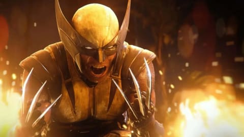A cinematic, close-up shot of the superhero Wolverine from the video game Marvel's Wolverine. He wears his iconic yellow and brown suit along with a matching pointed cowl mask that reveals only his aggressive, roaring mouth and glowing white eyes. He is crouched down in a battle-ready stance against a chaotic background filled with bright, fiery explosions and floating sparks. His metallic claws are fully extended from both of his gloved hands, reflecting the intense orange light of the surrounding fire.
