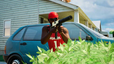 A modern video game screenshot from a third-person perspective depicts a stylized Black male character aiming a silver submachine gun with a large, black attached silencer directly at the camera. He wears a bright red bandana wrapped around his head, dark sunglasses, and a red basketball jersey with white vertical pinstripes and the word "BLOODS" above a large number "1" printed across the front in white letters. He stands outdoors in a suburban neighborhood behind a dense cluster of vibrant green bushes that obscures his lower body. Behind him, a worn blue hatchback car is parked in front of a light gray or light blue two-story residential house with horizontal siding under a partly cloudy sky. The lighting is bright and crisp, casting subtle shadows on the vehicle and the character's muscular arms as he grips the weapon with both hands.