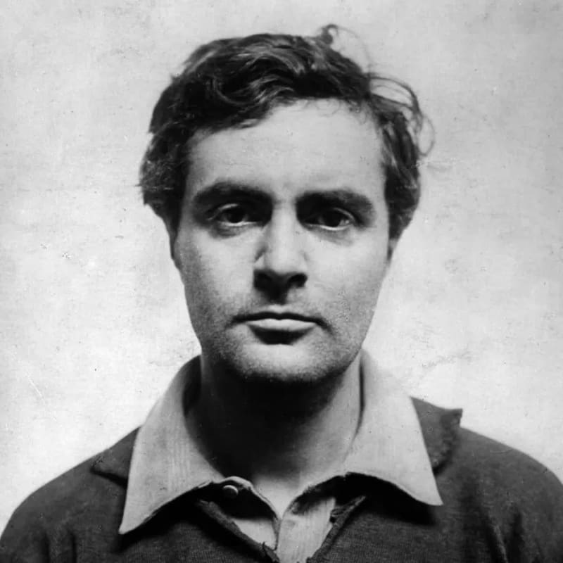 Amedeo Modigliani’s stay in Paris (1906–1920) is the defining narrative of the early 20th-century bohemian artist—a chaotic blend of genius, extreme poverty, and self-destruction. Arriving as a refined, well-dressed bourgeois youth from Italy, Paris quickly transformed him into "Modi" (a play on the French word maudit, meaning "damned"). He settled into the dilapidated studios of Montmartre and later Montparnasse, living alongside fellow avant-garde icons like Pablo Picasso, Diego Rivera, Juan Gris, and Jean Cocteau.While his peers began finding financial success, Modigliani remained destitute, frequently trading rapid portrait sketches for a glass of absinthe, a meal, or a place to sleep. He suffered from chronic tuberculosis, a highly stigmatized and untreatable disease at the time. To hide his physical decline and the coughing fits that would alienate him from society, Modigliani masked his symptoms behind a destructive addiction to hashish, absinthe, and heavy drinking. This volatile lifestyle fueled a fiery, erratic temperament; he was famous for tearing his clothes off in public, picking fights, and destroying his own artwork in fits of rage when unsatisfied.Despite his personal downward spiral, his creative output was fiercely disciplined. In 1917, he met Jeanne Hébuterne, a quiet 19-year-old art student from a conservative Catholic family. Despite her family's fierce disapproval of her relationship with a penniless Jewish artist, she became his common-law wife, his ultimate muse, and the mother of his daughter. She endured his frequent absences and substance-fueled tirades, captured by Modigliani in more than 20 delicate, haunting portraits that are now considered his most tender masterpieces.The tragic climax of his Parisian life unfolded rapidly in January 1920. After days of silence from his Montparnasse studio, a neighbor broke in to find Modigliani delirious in bed, freezing and dying of tubercular meningitis, while a heavily pregnant Jeanne wept beside him holding his hand. Modigliani died at the Hôpital de la Charité on January 24, 1920, at the age of 35. Overcome by grief and completely undone by the loss of her partner, the 21-year-old Jeanne threw herself from a fifth-floor window the very next morning, killing herself and their unborn second child. Modigliani was given a massive, regal funeral attended by nearly the entire Paris artistic community, cementing his transition from a bohemian outcast to a legendary martyr of modern art.