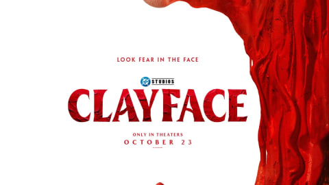 A striking movie poster for a film titled "Clayface" featuring a dramatic composition dominated by a large, close-up face split down the center. On the left side, a realistic human eye and smooth skin are visible, while the right side morphs into a swirling, textured, blood-red clay-like substance that forms a massive, gaping frame around the rest of the image. The title "CLAYFACE" is printed in a bold, stylized, red serif font in the center of the stark white background, accompanied by the tagline "LOOK FEAR IN THE FACE" above it and the "DC STUDIOS" logo. Below the title, the text reads "ONLY IN THEATERS" and "OCTOBER 23". At the bottom of the white space, a small, lone figure wearing a red hooded jacket and sunglasses stands amidst a jagged, miniature red cityscape formed by the swirling clay texture.