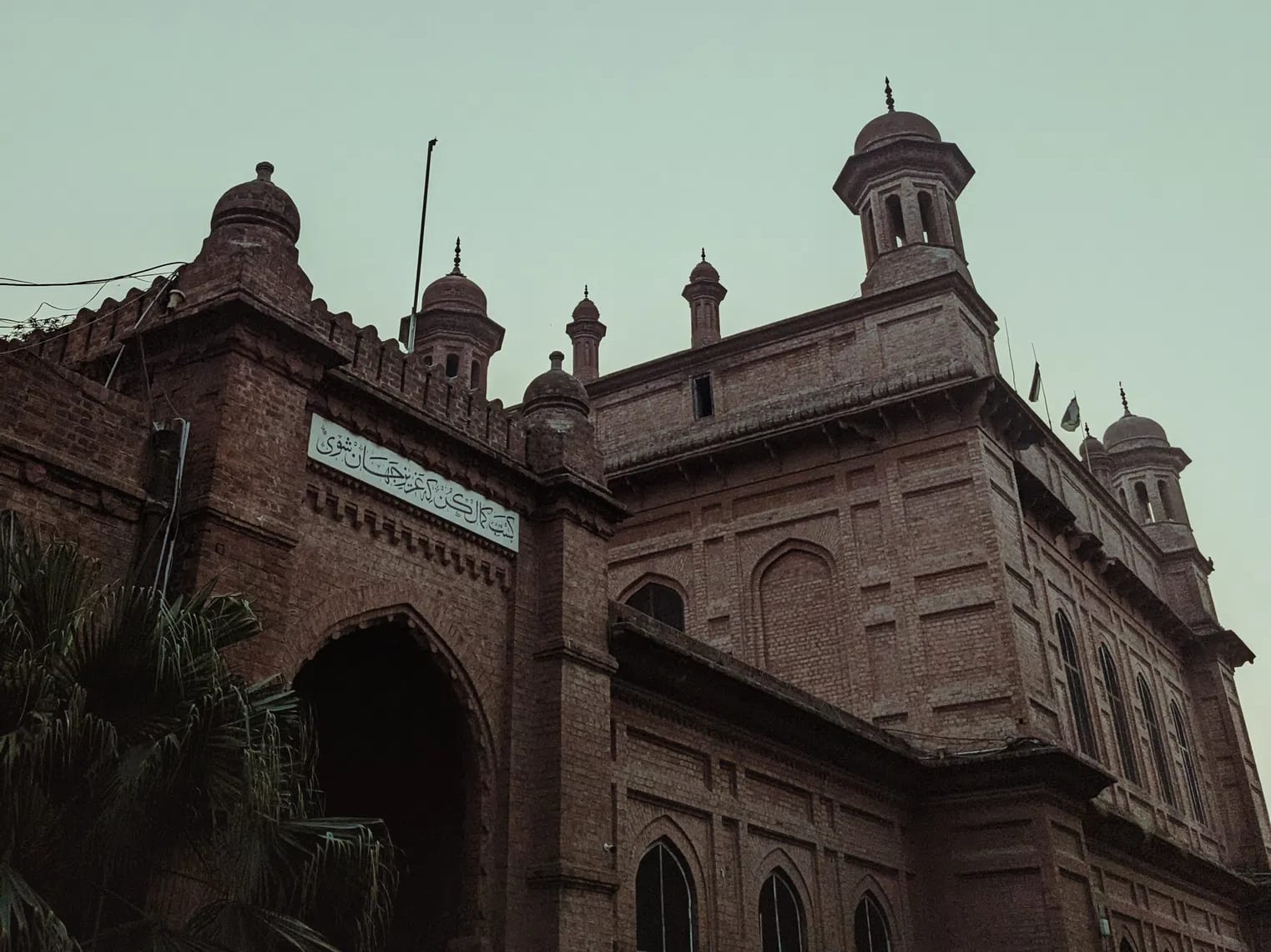 The National College of Arts (NCA) Lahore stands as Pakistan's premier, federally chartered public art university and the second-oldest art institution in South Asia. Founded in 1875 as the Mayo School of Industrial Arts to safeguard and document regional craftsmanship under the British Raj, the institution's pedagogical roots were deeply influenced by the global Arts and Crafts Movement. Its inaugural principal, British artist and curator John Lockwood Kipling, established a curriculum that uniquely fused traditional Punjabi and Mughal craft techniques with European perspective-drawing methods. This design-and-craft ethos crystallized architecturally in the college's historic campus on Mall Road. Designed by the pioneering master builder Bhai Ram Singh and constructed by the legendary engineer Sir Ganga Ram, the iconic campus features red-brick, Indo-Saracenic facades, protective verandas, structural arches, and ornamental chatris. The historic Kipling Block, whose foundation stone was laid in 1880, serves as a physical anchor directly adjacent to the Lahore Museum, which was originally curated alongside the school to provide students with raw reference material.Following Pakistan's independence, the facility underwent a radical modernization in 1958 under the guidance of its first Pakistani principal, Mian Barkat Ali. Restructured into the National College of Arts, the university successfully decolonized its curriculum by importing global design methodologies and integrating experimental, non-conformist practices. Today, the institution organizes its academic scaffolding across the faculties of Art, Design, Architecture, Film & Television, and Performing Arts. It accommodates diverse specializations ranging from traditional Miniature Painting and Ceramic Design to contemporary Musicology and Visual Communication Design. Entrance is exceptionally competitive, drawing talent nationwide via a strict, multi-tiered provincial quota system, written testing, and rigorous live drawing examinations. This immersive, studio-centric cultural melting pot has birthed generations of visionary changemakers. Its alumni include modern art pioneers like Zahoor ul Akhlaq and Salima Hashmi, alongside prominent contemporary cultural icons like Ali Zafar and Ayesha Omar. Expanding its national reach, NCA also hosts specialized satellite campuses—including its Rawalpindi Campus and the newly inaugurated Gilgit-Baltistan Campus—solidifying its role as a monumental pillar of artistic scholarship, creative freedom, and cultural preservation across the region.