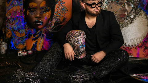 Sir Nicholas Lucius is a Tampa-based contemporary mixed-media painter, avant-garde visionary, and creative entrepreneur. His artistic approach is rooted heavily in emotional maximalism, haute couture fantasy, and deliberate theatrical excess.Art Style and Creative PhilosophyLucius creates heavily textured, monumental artworks using an intricate layering process. His distinct style explores the human subconscious and serves as a fierce refusal against standard social expectations to play small or stay quiet. His pieces are recognizable by several signature elements:Tactile Excess: He intentionally tears images apart and violently pushes thick pigments around his canvases.Luxury Textures: Pieces frequently incorporate high-end physical embellishments including Swarovski crystals, diamond dust, and rhinestones.Vibrant Glamour: His portfolio features intense, unapologetic use of vivid colors and deep emotional narratives.Rise to Cultural ProminenceLucius's rapid rise in contemporary creative culture was significantly amplified by a viral pop-culture interaction. During an arena performance, global pop icon Lady Gaga noticed one of his unique art pieces, walked out to the edge of the stage, and autographed it live. The widely circulated footage online solidified his name among massive fanbases and contemporary art collectors. He has also been recognized locally as a featured artist for events like the Dali Dozen at the Salvador Dalí Museum.