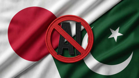 A close-up view of two rippling fabric flags, the flag of Japan on the left with its prominent red circle and the flag of Pakistan on the right with its white star and crescent moon against a green field, intersecting diagonally. Positioned directly over the center where the flags meet is a circular, red embroidered anti-AI ban sign featuring a black letter "A" crossed out by a diagonal red line.