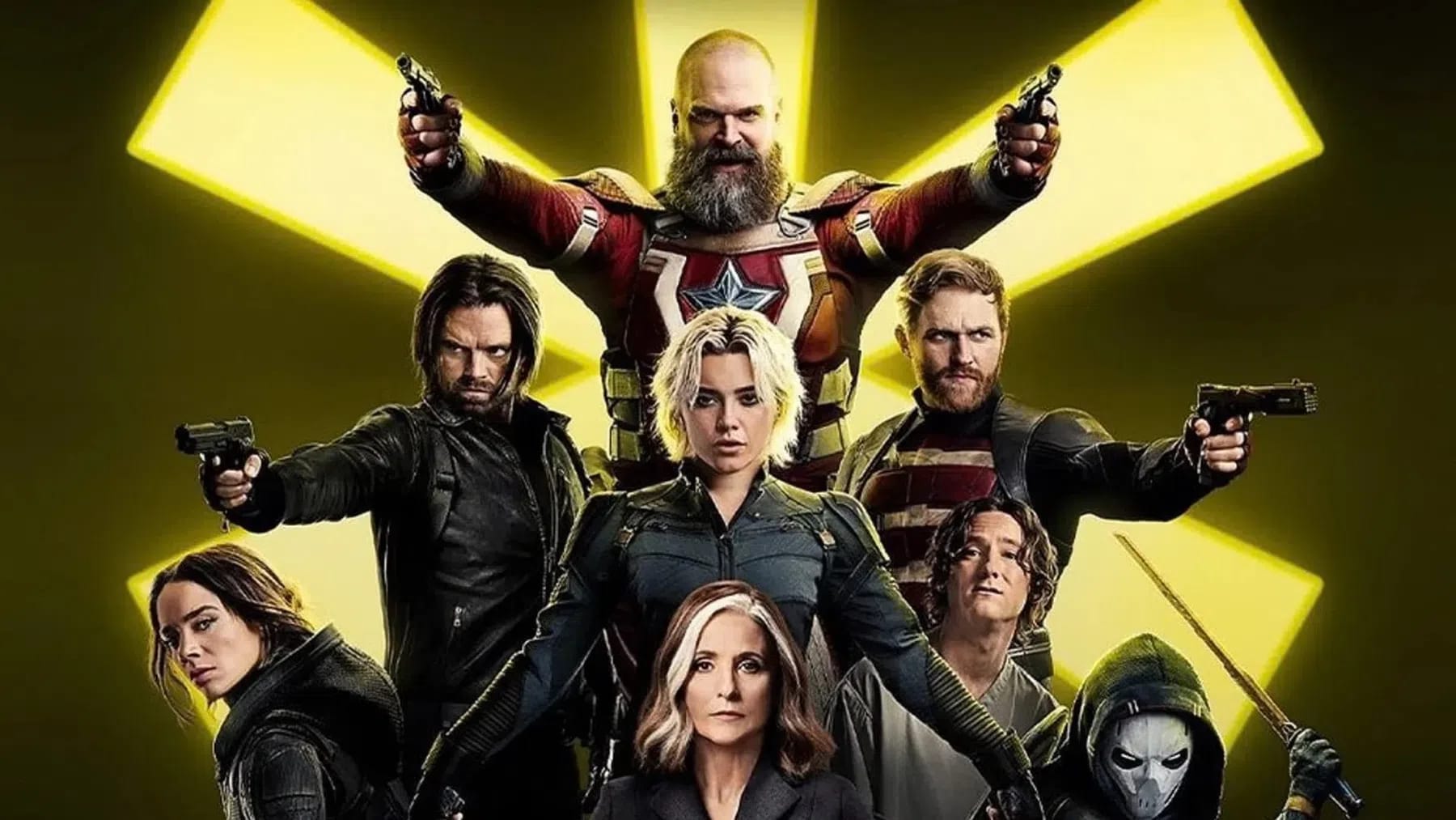 Thunderbolts: A group of armed antiheroes and mercenaries from the Marvel Cinematic Universe stand in a powerful, layered triangular formation against a glowing, yellow, six-pointed star backdrop. At the top apex stands the heavily bearded Red Guardian in his red suit, triumphantly holding two pistols in the air. Below him, the central focus is Yelena Belova in a dark tactical suit, flanked by a determined Bucky Barnes on her right holding a handgun, and John Walker (U.S. Agent) on her left, also aiming a pistol. In the lower tier, Ghost peers intensely from the bottom left, Valentina Allegra de Fontaine stands calmly at the center bottom with her signature white-streaked hair, a long-haired Bob (Sentry) looks upward anxiously to her right, and a hooded Taskmaster holds a sword at the bottom right.