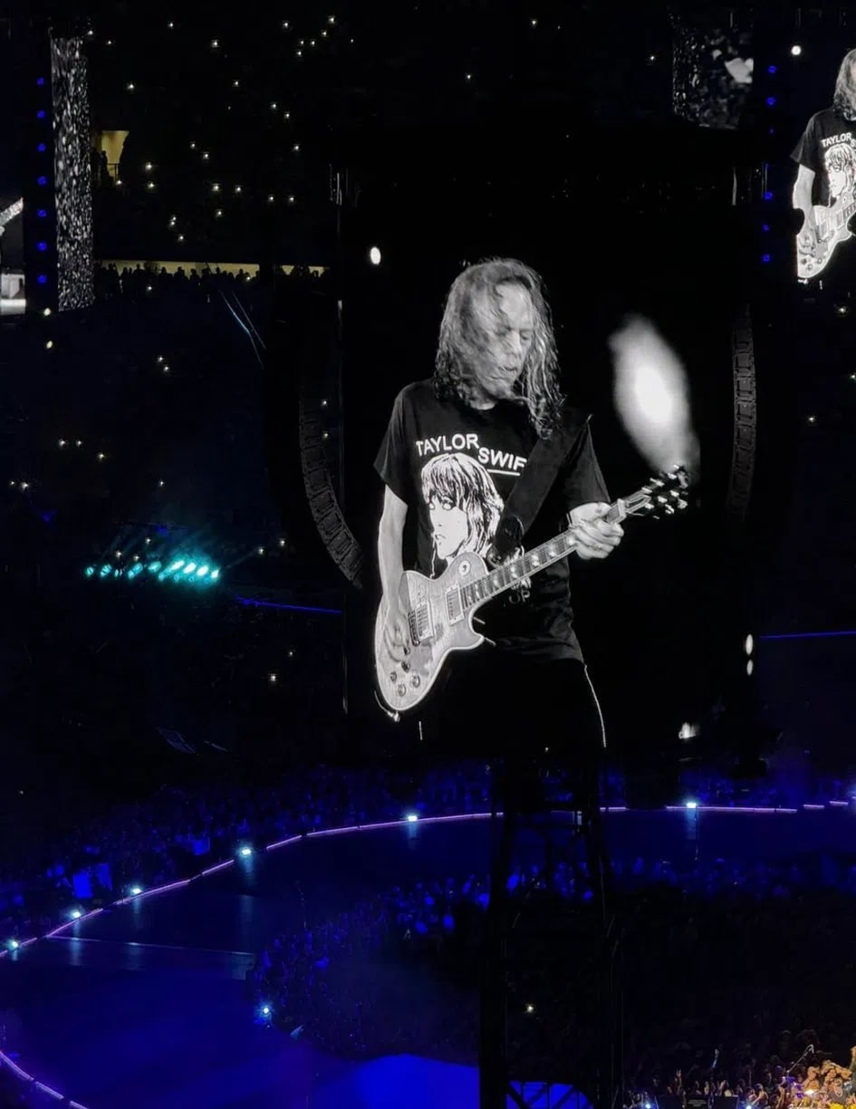 Metallica lead guitarist Kirk Hammett went viral for wearing a tongue-in-cheek "Taylor Swift Is A CIA Psyop" t-shirt on stage during the band's M72 World Tour. The unexpected crossover between the legendary thrash metal guitarist and the pop megastar quickly sparked widespread conversation across social media platforms like X, Reddit, and TikTok.