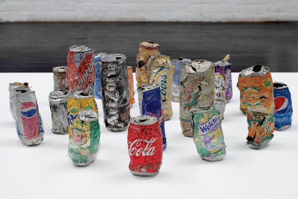 Nobutaka Aozaki's solo exhibition "Soda • Chips • Lottery • Cards" at Kai Matsumiya in New York City features sculptural works created from discarded bodega items and urban debris. Running from February 14 to March 28, 2025, the show reimagines found street cans, chip bags, and paper ephemera as artistic, high-value objects.