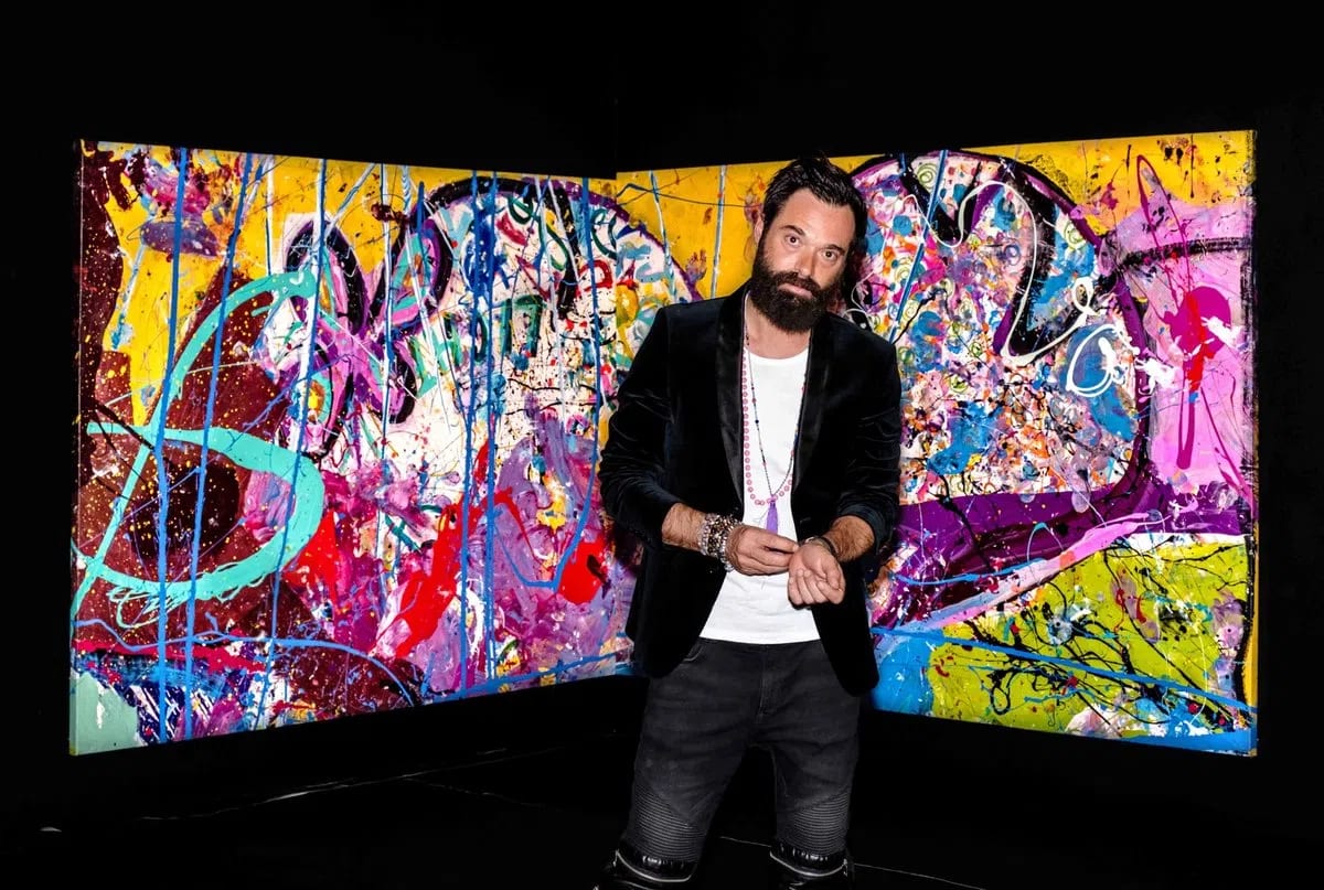 Sacha Jafri, a prominent British contemporary artist, stands confidently in front of a vibrant, multicolored abstract section of his record-breaking masterpiece, titled The Journey of Humanity. Officially certified by the Guinness World Records as the largest art canvas in the world, the monumental artwork spans an astonishing 17,000 square feet. Jafri meticulously created this multi-paneled initiative over several months while in lockdown at Dubai's Atlantis, The Palm. He combined thousands of gallons of paint, intricate layers of splatters, and poignant artwork contributions submitted by children from over 140 countries. Although the vast scale of the canvas was originally planned to be divided into 70 distinct segments for separate auctions, the entire painting was purchased as a whole by a single bidder for a historic $62 million at a charity auction. This extraordinary sale catapulted Jafri into the ranks of the most expensive living artists while simultaneously raising substantial funding to support global health, education, and digital connectivity initiatives for children in underserved communities through partnering organizations like Dubai Cares, UNICEF, and UNESCO.