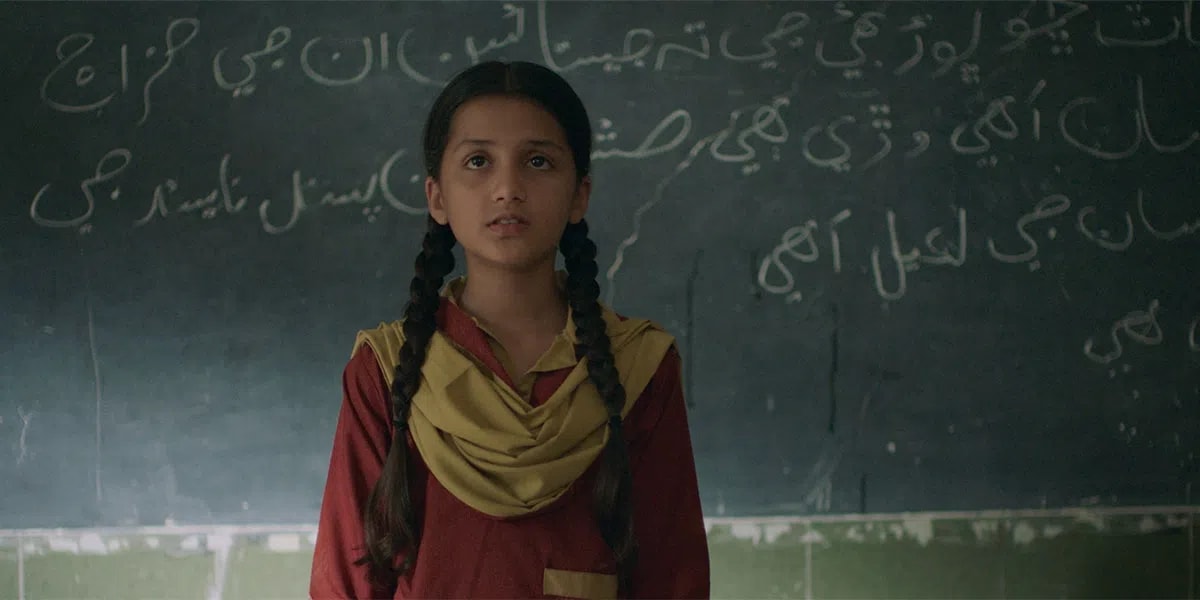 The term "Ghost School" refers to both a critical socio-political issue in Pakistan and an internationally acclaimed 2025 feature drama film directed by Seemab Gul that highlights this crisis. In reality, a "ghost school" is an official term for an educational institution that exists only on paper or has been completely abandoned; while the government continues to allocate monthly budgets for maintenance and teacher salaries, the funds are routinely siphoned off by corrupt local politicians or "ghost teachers" who get paid but never show up, leaving thousands of rural school buildings to fall into ruin or be repurposed as private cattle sheds. Gul’s film uses a blend of social and magical realism to explore this structural corruption through the eyes of Rabia, a precocious 10-year-old girl in a rural village who investigates why her school has suddenly been shut down under the local pretense that it is haunted by a Jinn. After earning widespread acclaim at major international festivals like the Toronto International Film Festival (TIFF) in September 2025 and the Berlin International Film Festival (Berlinale) in February 2026, the film recently sparked widespread controversy on August 4, 2026, when the Sindh Board of Film Censors denied it a screening certificate, declaring it "unsuitable for public screening" in the very province where much of the real-world crisis persists.