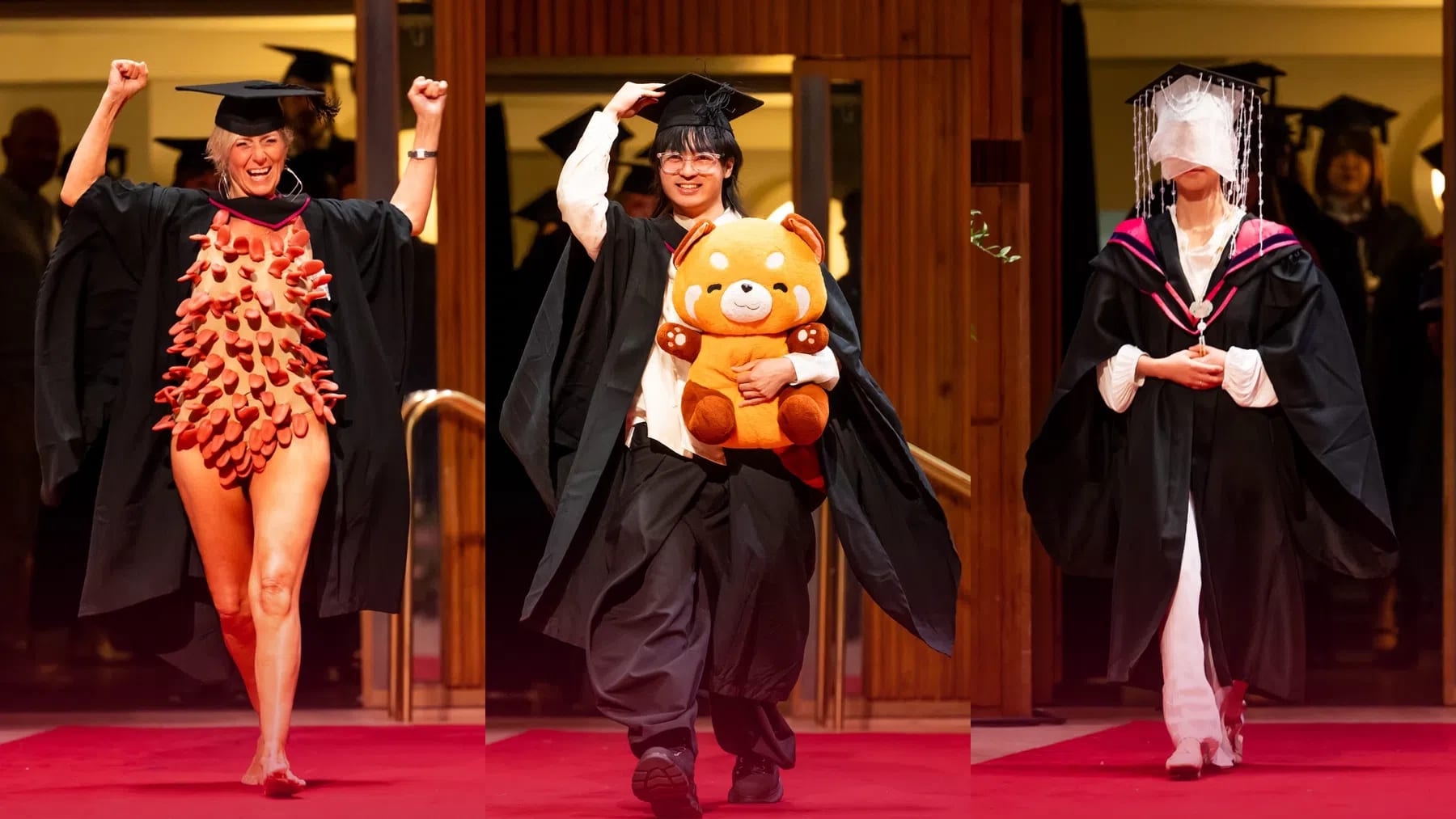 A three-panel composite photograph featuring three UAL graduates displaying playful, surreal, and avant-garde style choices on the graduation red carpet.  Left Panel: A graduate with short, styled blonde hair cheers ecstatically with both arms raised in the air, smiling brightly. She wears a black academic gown over a striking nude body suit entirely covered in hundreds of dense, protruding reddish-brown fabric tubes or finger-like spikes that project outward across her entire torso and upper legs, giving a heavily textured, sea-anemone effect. She walks barefoot along the red carpet wearing a black mortarboard cap.  Center Panel: A graduate with dark layered hair and round glasses smiles happily as they walk forward holding a large, plush orange-and-brown red panda soft toy in both arms against their chest. They wear a classic black graduation gown draped over a white collared dress shirt, dark vest, and voluminous wide-leg black trousers, adjusting their mortarboard cap with one hand as they walk.  Right Panel: A graduate walks along the red carpet in a dramatic, veiled ensemble. Attached to their black mortarboard cap is a semi-sheer white face veil lined with cascading strings of sparkling crystal beads that completely obscure their face. They wear a traditional black graduation gown with vibrant pink shoulder lining over a white long-sleeve garment with billowy gathered cuffs, holding their hands gently clasped in front of them as they step forward.
